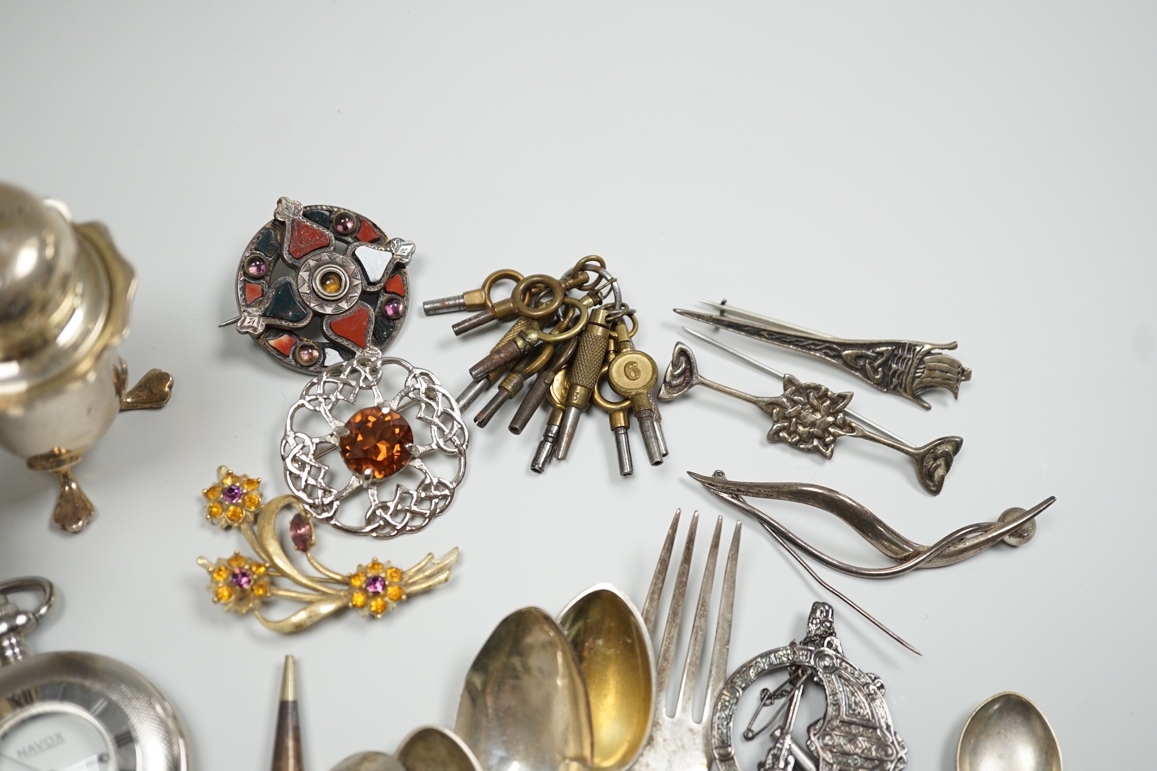 Sundry small silver including two sauceboats, napkin rings, mounted glass condiment bottle, pepperette, pair of silver gilt preserve spoons, minor flatware including white metal, a 1920's Georg Jensen silver cream ladle,